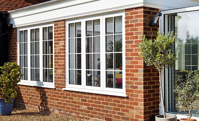 White timber double glazed casement windows with cottage bars on UPVC orangery from Anglian Home Improvements