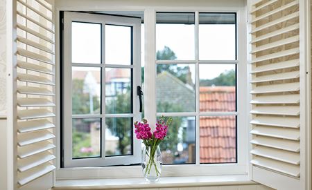 Traditional timber window featuring cottage bar glazing effect and timber shutters