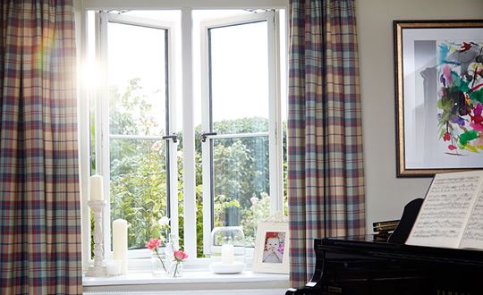 White timber side hung casement windows with cottage bars and central mullion from Anglian Home Improvements