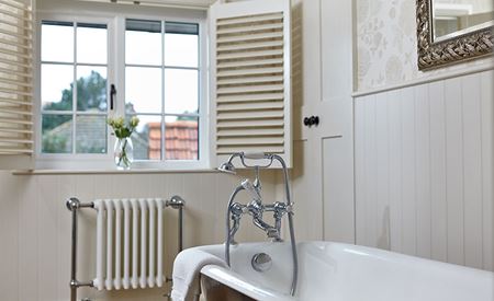 Bathroom timber window featuring cottage bar glazing effect and timber shutters