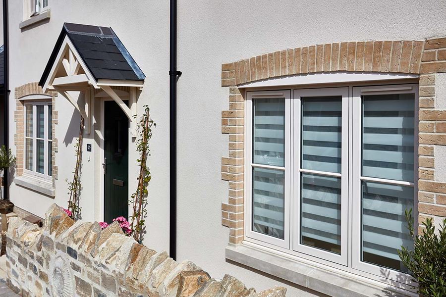 Front of house view of flush uPVC casement window finished in Cream from the Anglian flush window range