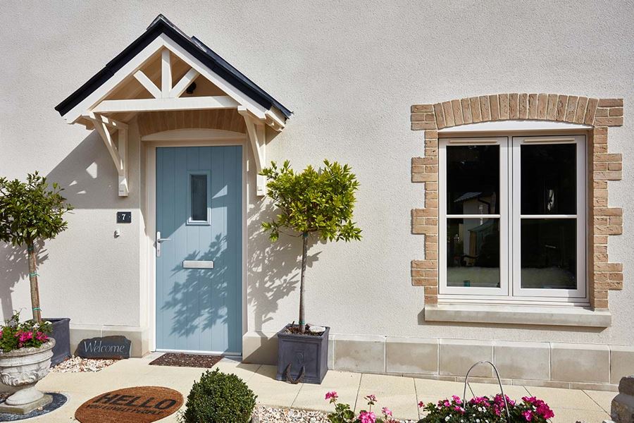 Cream flush uPVC casement window and Duck Egg Blue composite front door from Anglian Home Improvements