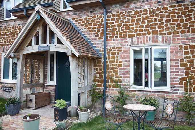 White uPVC flush window at front of stone house