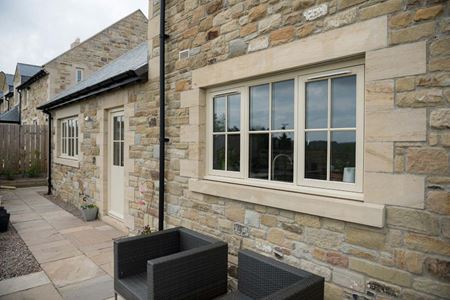 Cream wooden flush window and back door at back of house