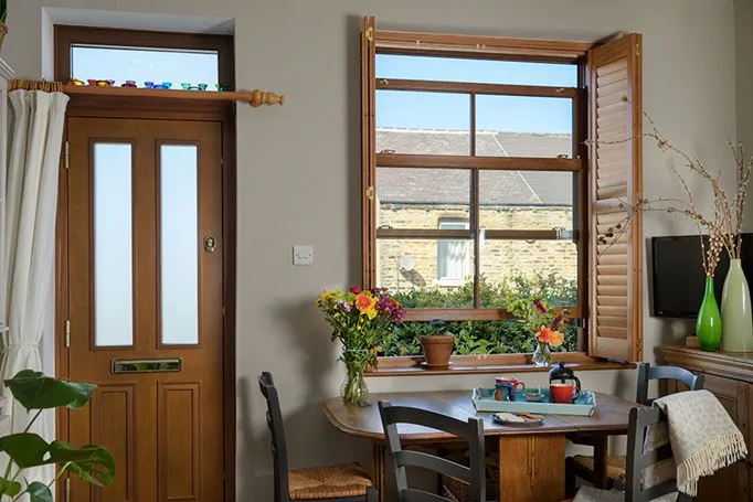 Dark woodgrain uPVC sash window with matching front door interior