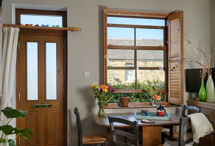 Golden oak uPVC sliding sash window and matching front door
