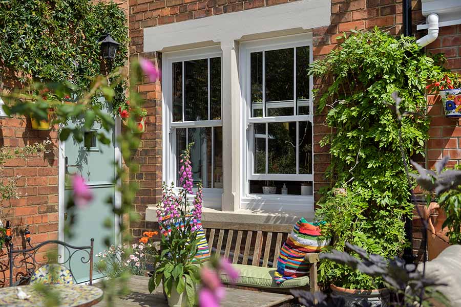 White uPVC sash window in garden in open position