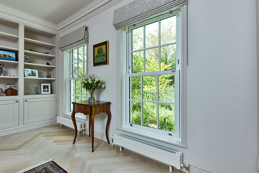 White uPVC vertical sliding sash windows with cottage bars dual interior