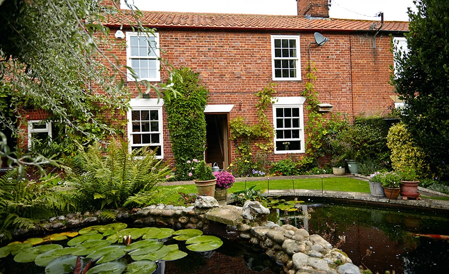 Whole house double glazing replacement of White wooden sash windows with cottage bars from Anglian Home Improvements