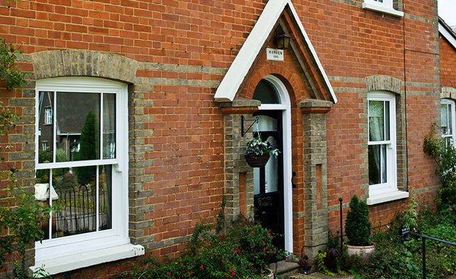 White timber sash windows with cottage bars on traditional home from the Anglian sash window range
