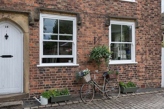 White wooden sliding sash windows at front of house