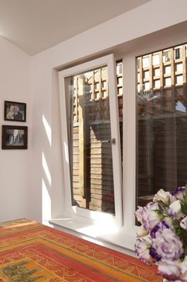 Interior view of white uPVC tilt and turn window with chrome handle from the Anglian tilt and turn window range