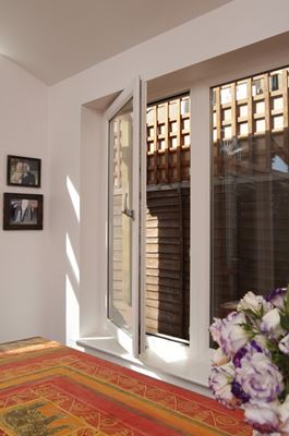 Interior view of white uPVC tilt and turn window turned to the open position from the Anglian tilt and turn window range