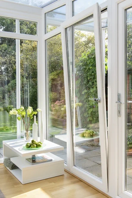 White uPVC Tilt & Turn window in tilt position within a conservatory