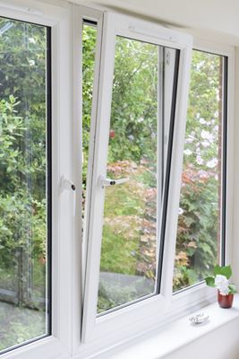 White uPVC tilt and turn window with white window handles in the tilted open position