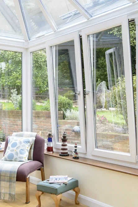 White uPVC Tilt & Turn window in the tilt position within a conservatory