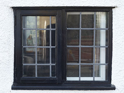 Black secondary glazing on a window with lead bars from the Anglian secondary glazing range