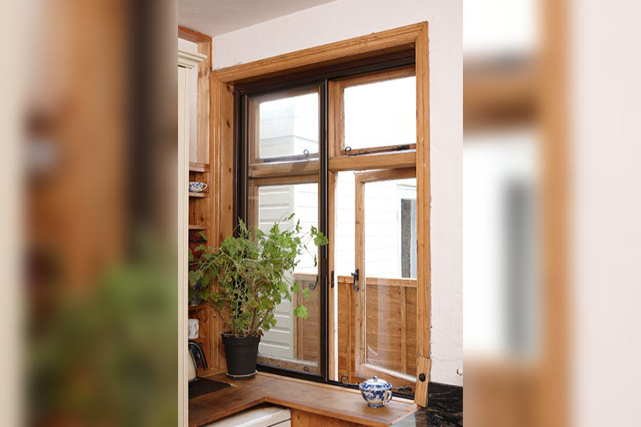 Black secondary glazing on brown window from the Anglian secondary glazing range