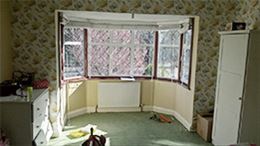 Customer testimonial before white uPVC canted bay window from the Anglian Home Improvements