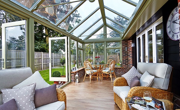 A wooden Edwardian conservatory in Sage Green