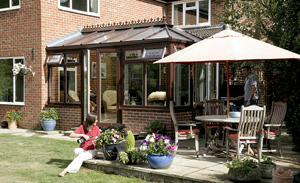 Large uPVC conservatory finished in dark woodgrain from the Anglian classic conservatory range