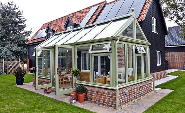 Large uPVC garden room conservatory finished in Sage Green from the Anglian conservatory range