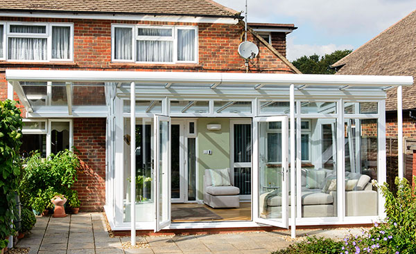 Large white uPVC veranda conservatory with French doors from the Anglian conservatory range