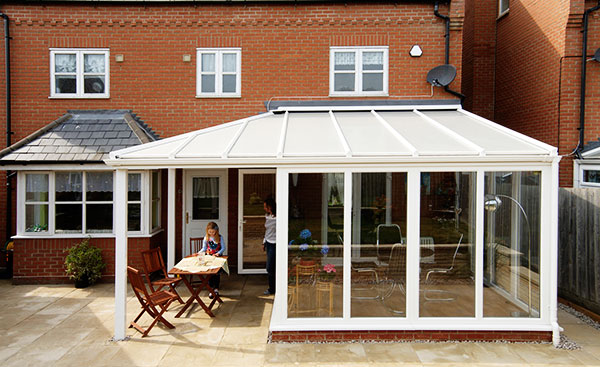 White uPVC veranda conservatory on modern home from the Anglian conservatory range