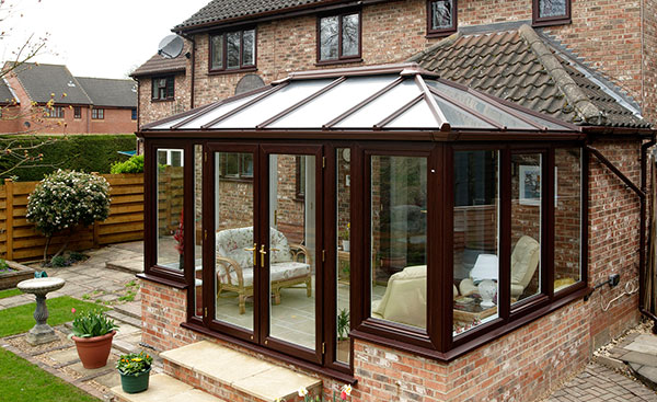 Conservatory in Dark Woodgrain uPVC from Anglian Home Improvements