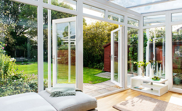 Finished garden room conservatory with French doors in white uPVC from Anglian Home Improvements