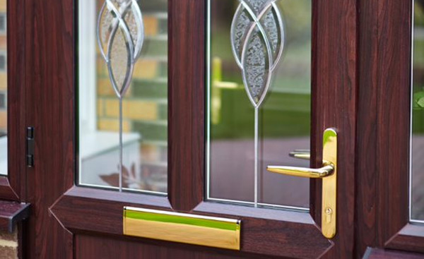 Front door in Dark Woodgrain with etched decorative glass design from Anglian Home Improvements