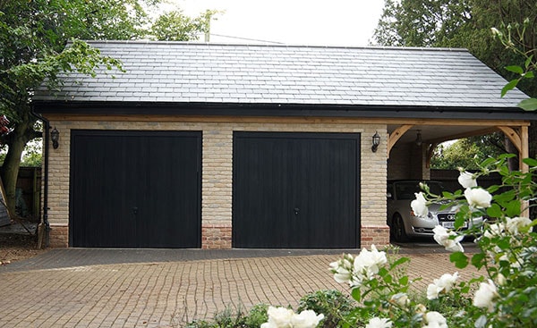 Two Black GRP one piece garage doors