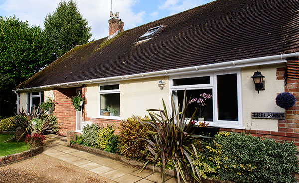 Bungalow with replacement White uPVC casement windows from Anglian Home Improvements
